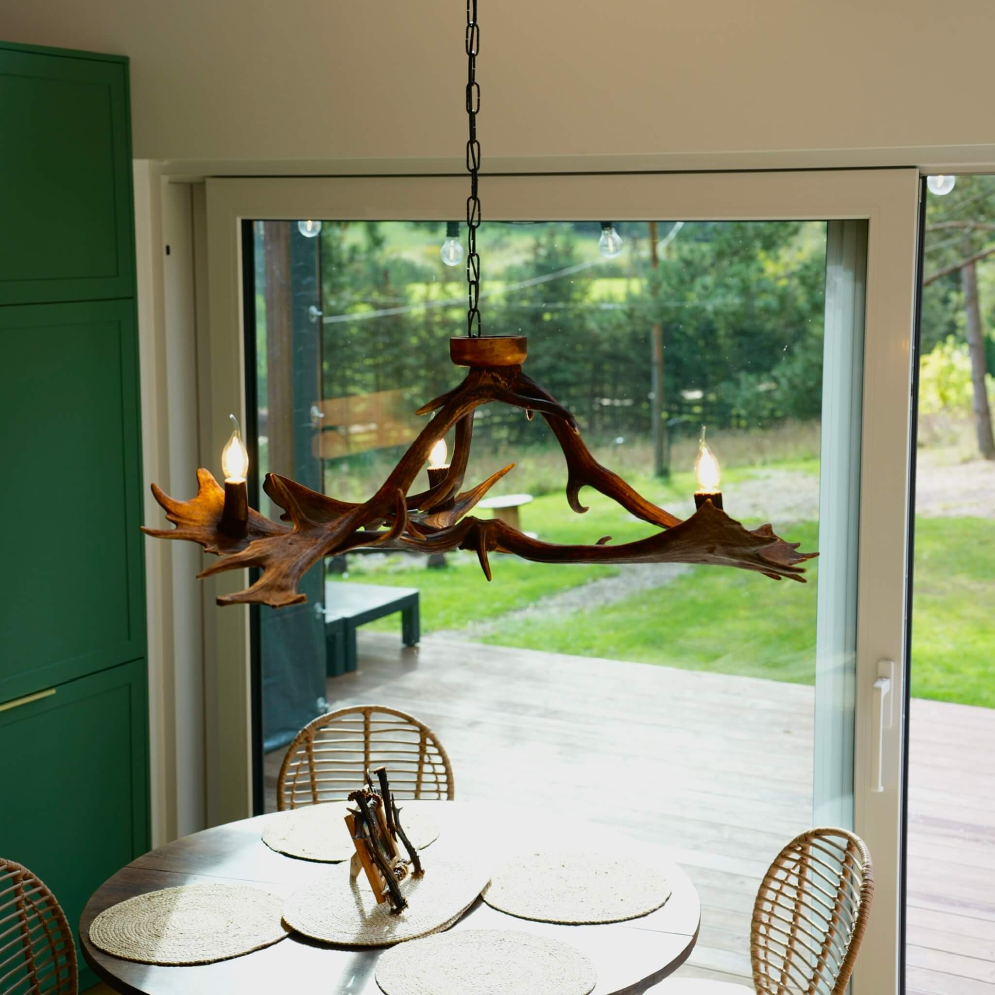 Rustic low antler chandelier with three lights, perfect for a cabin or lodge aesthetic.