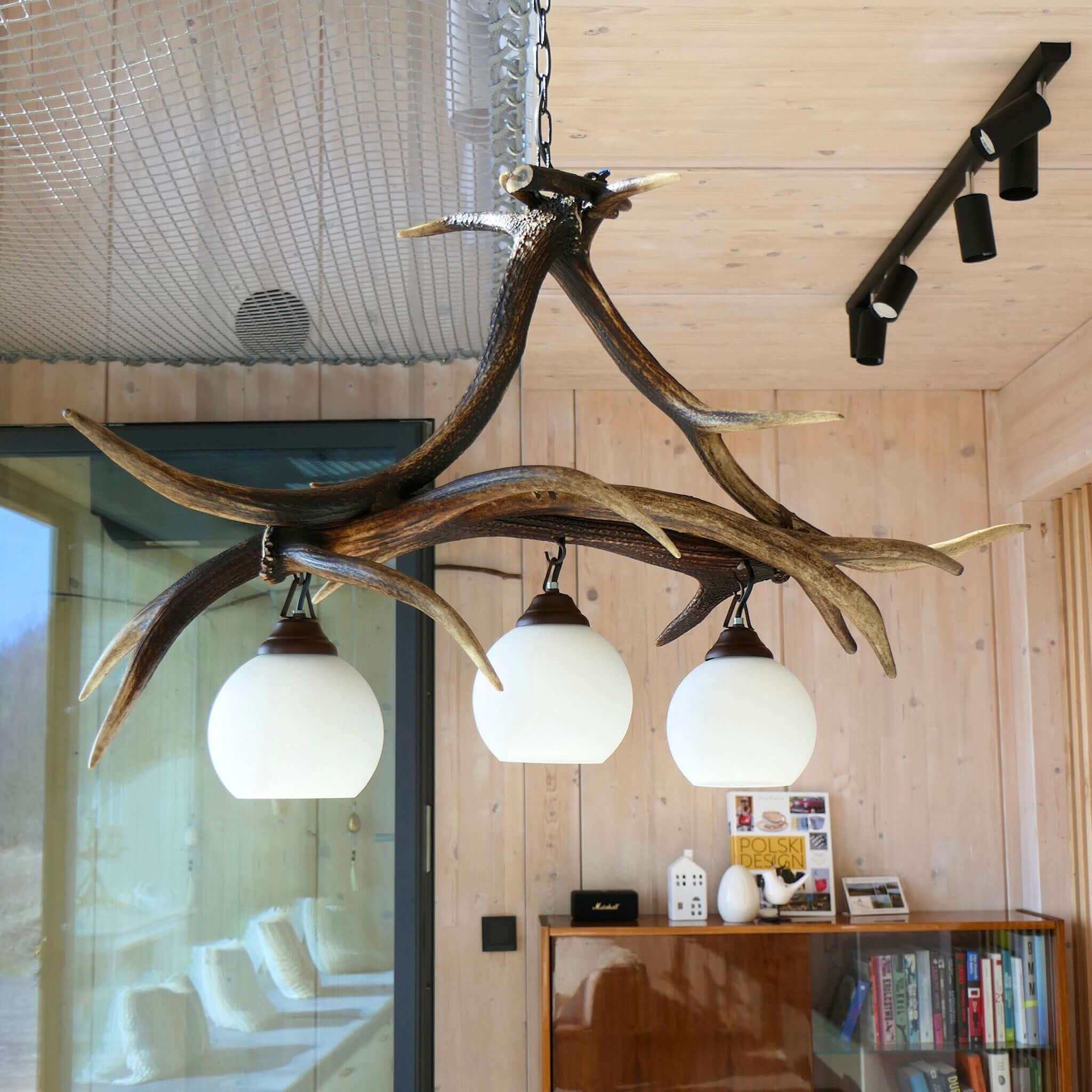 Real deer antler light fixture in modern living room.
