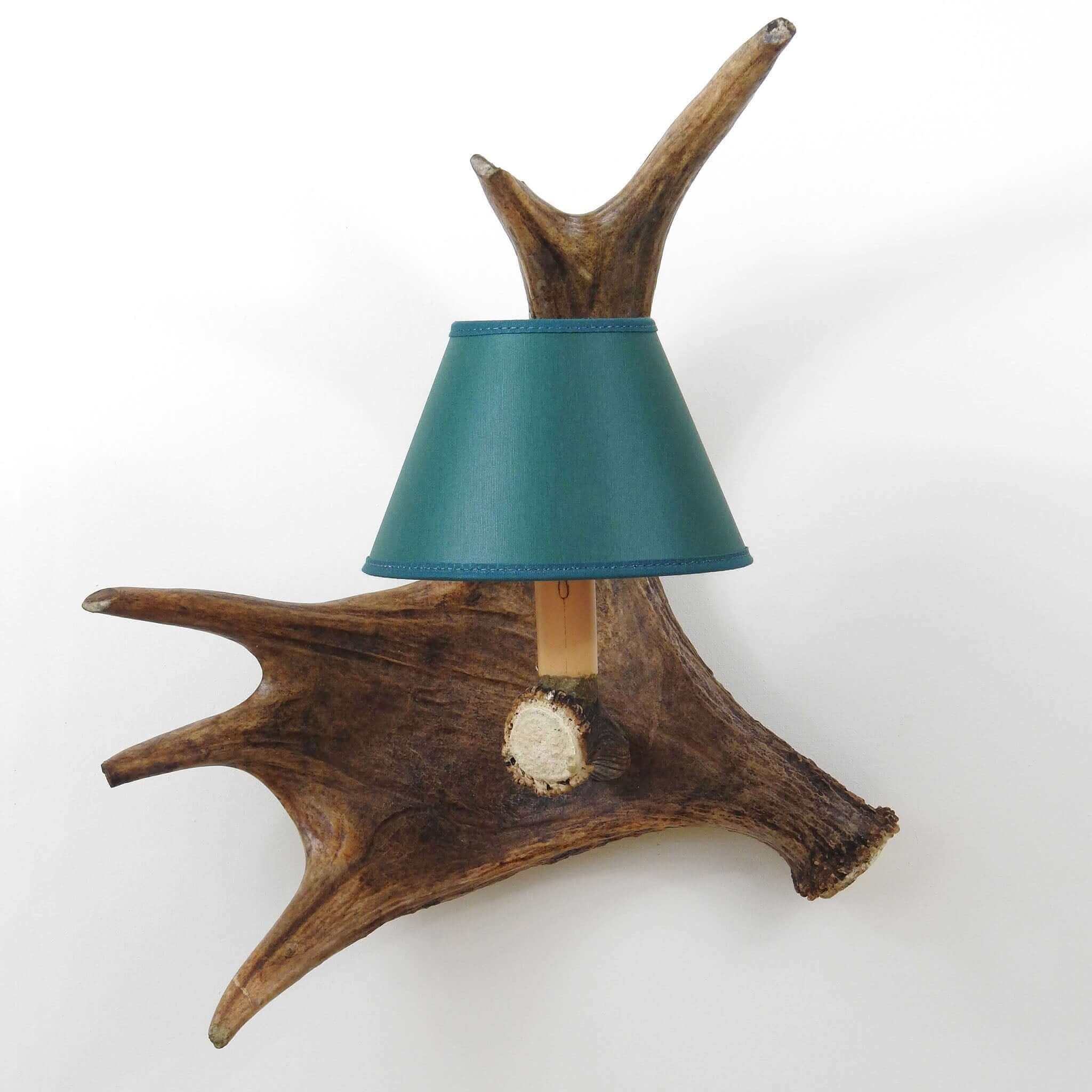 Antler wall chandelier with green shade.