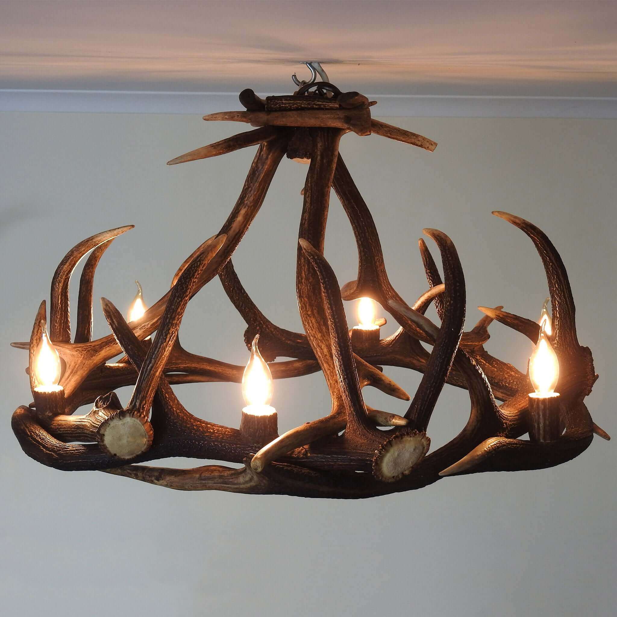 Round shape chandelier made of red deer antlers.