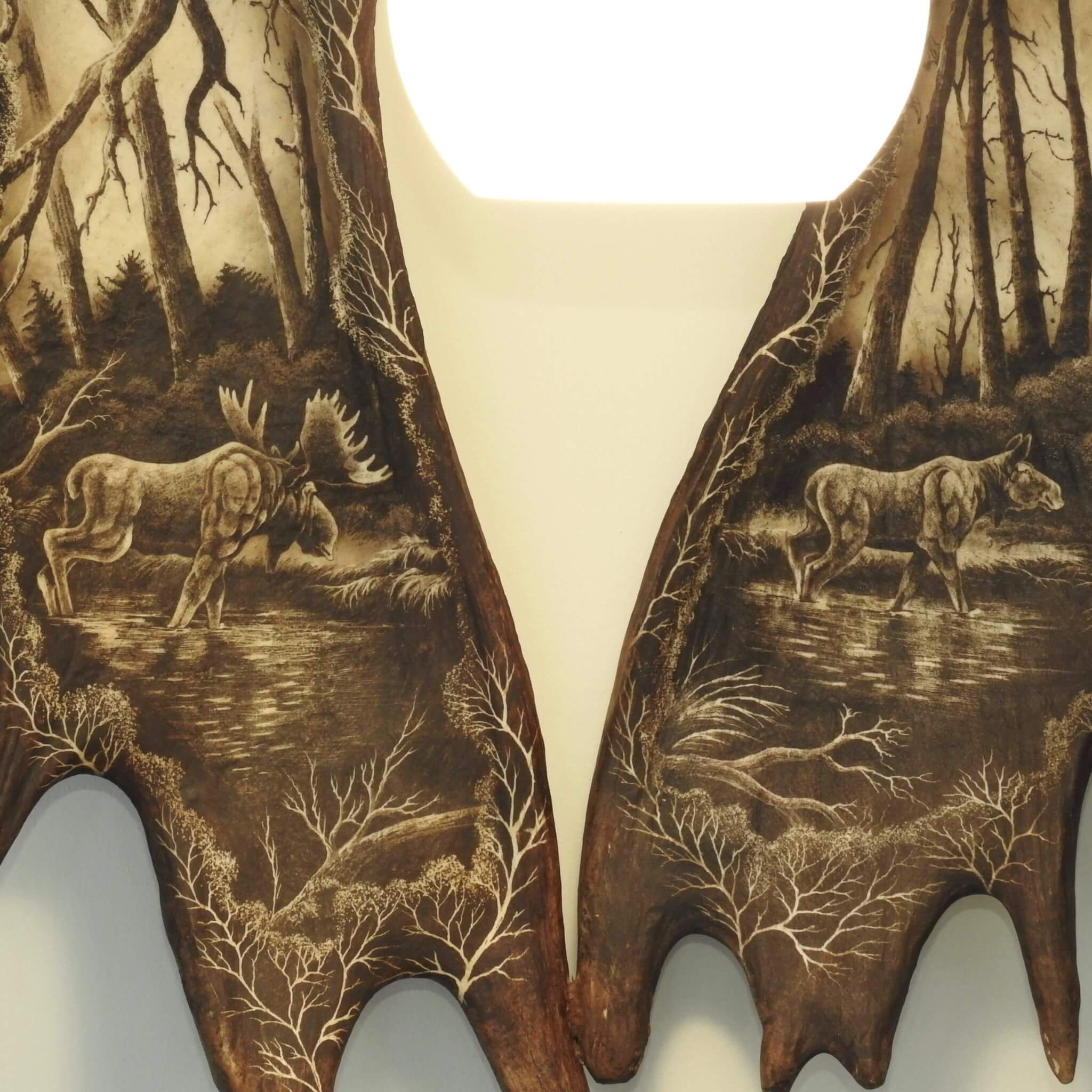 Male and female of moose carved in moose antler set.