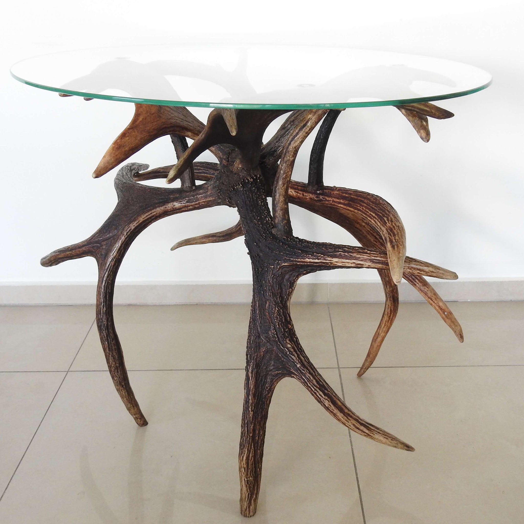 Glass top farmhouse antler table.