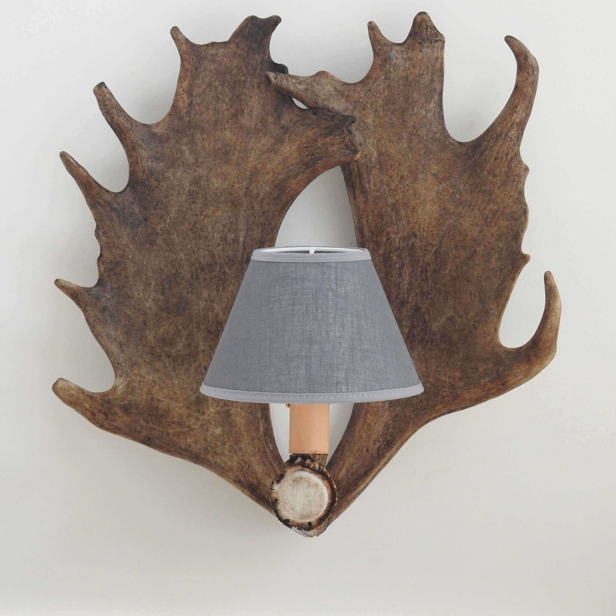 Aantler wall sconce with grey shade.