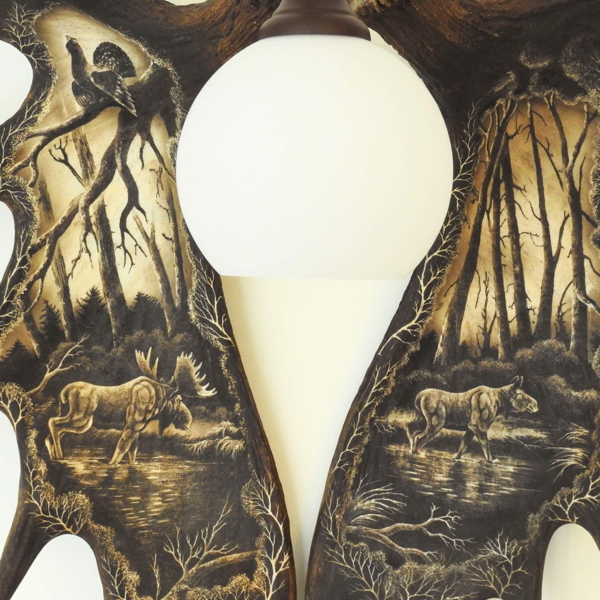 Sconce made of moose antler set with carvings.