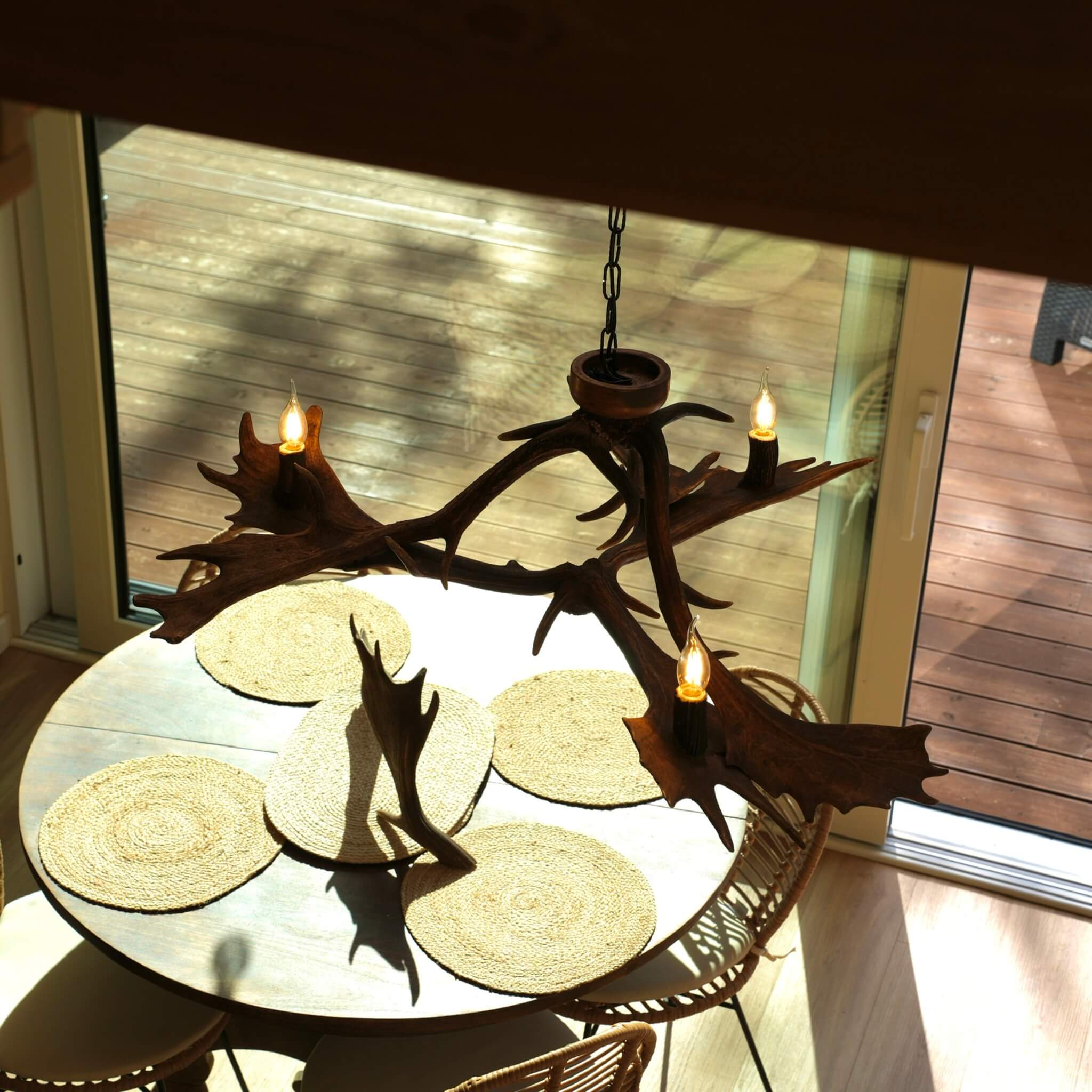 Handcrafted low-profile antler chandelier designed with three light fixtures.
