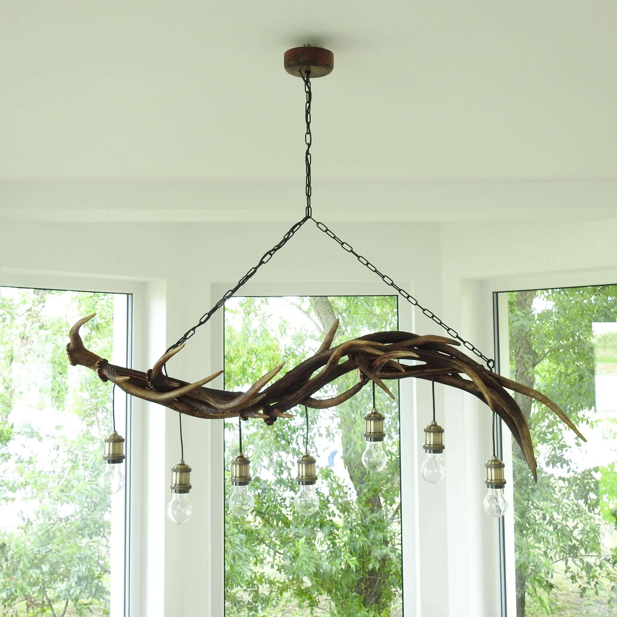 Deer antler chandelier with 7 bulbs pointed down.