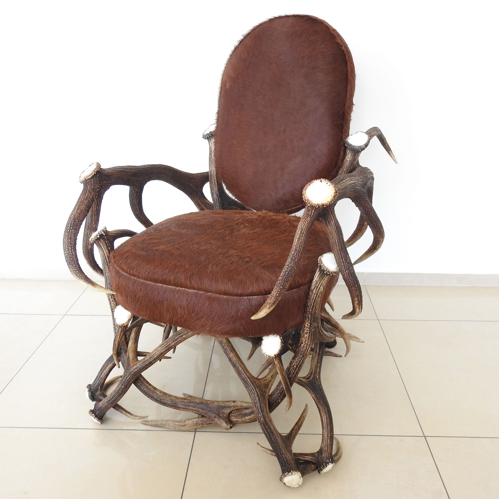 Real antler armchair with cow fur upholstery.