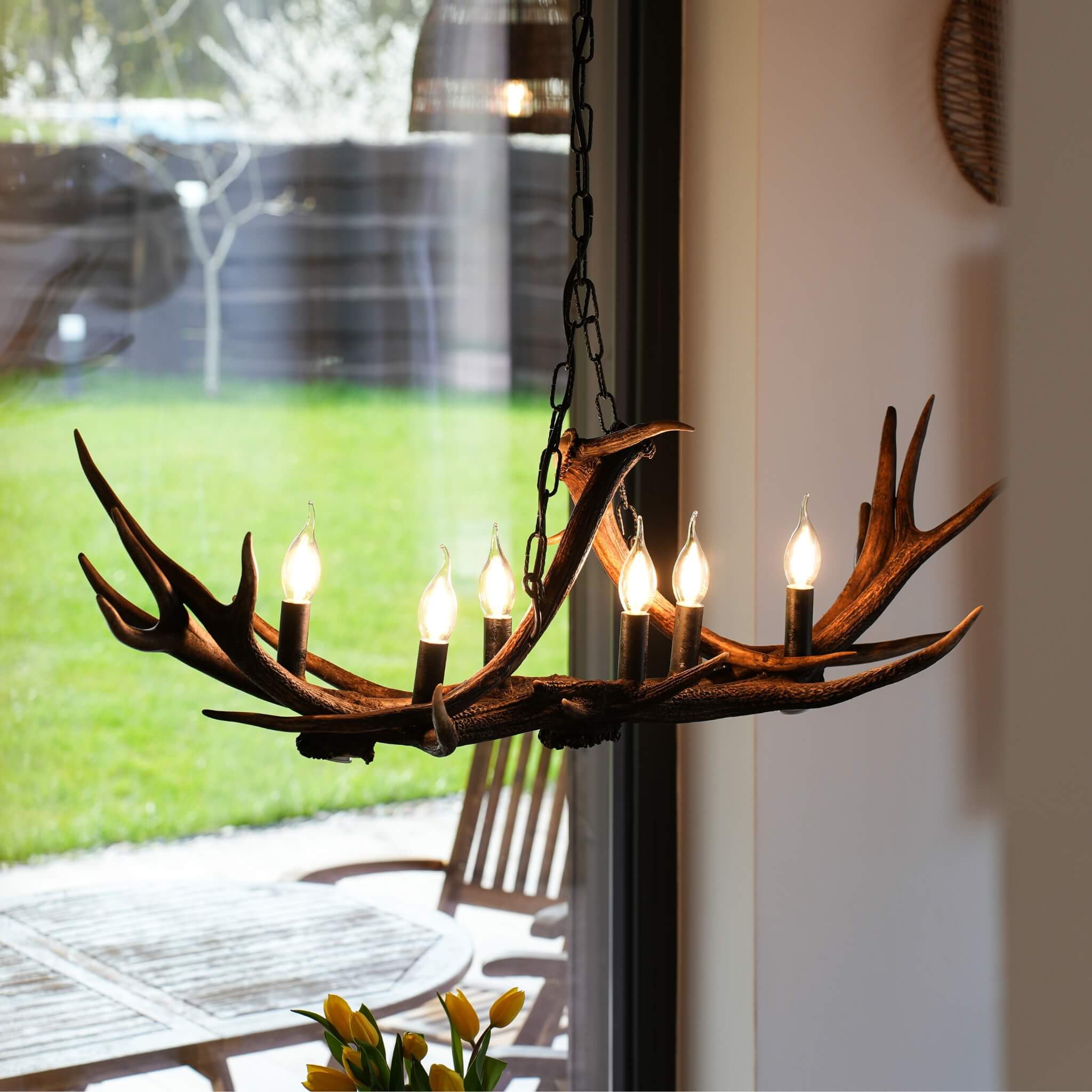 Antler chandelier hanging on chain.