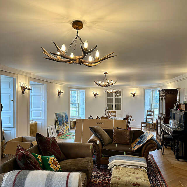 Real antler sconces and chandeliers in livingroom.