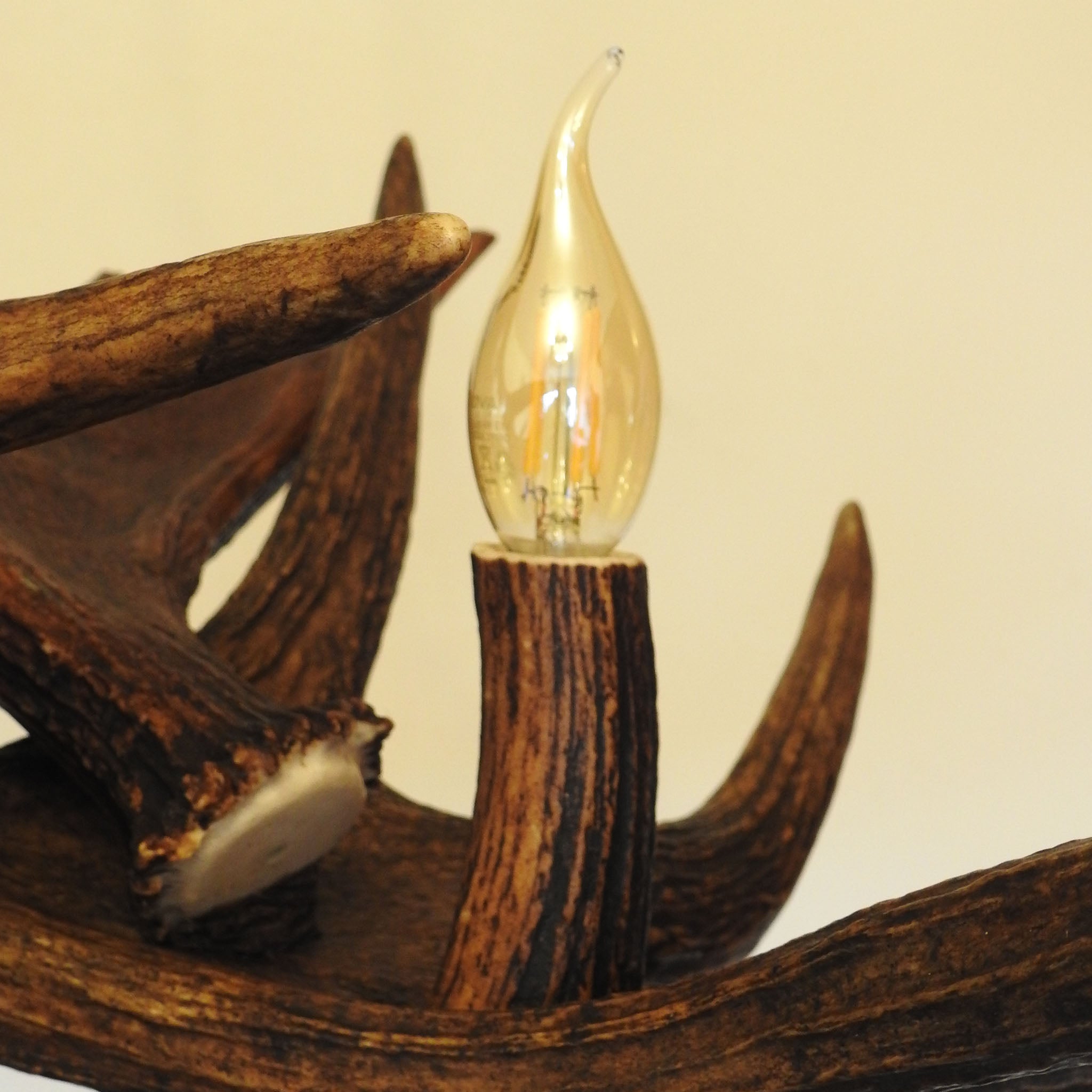 Bulb cover made of real antler in moose antler chandelier.