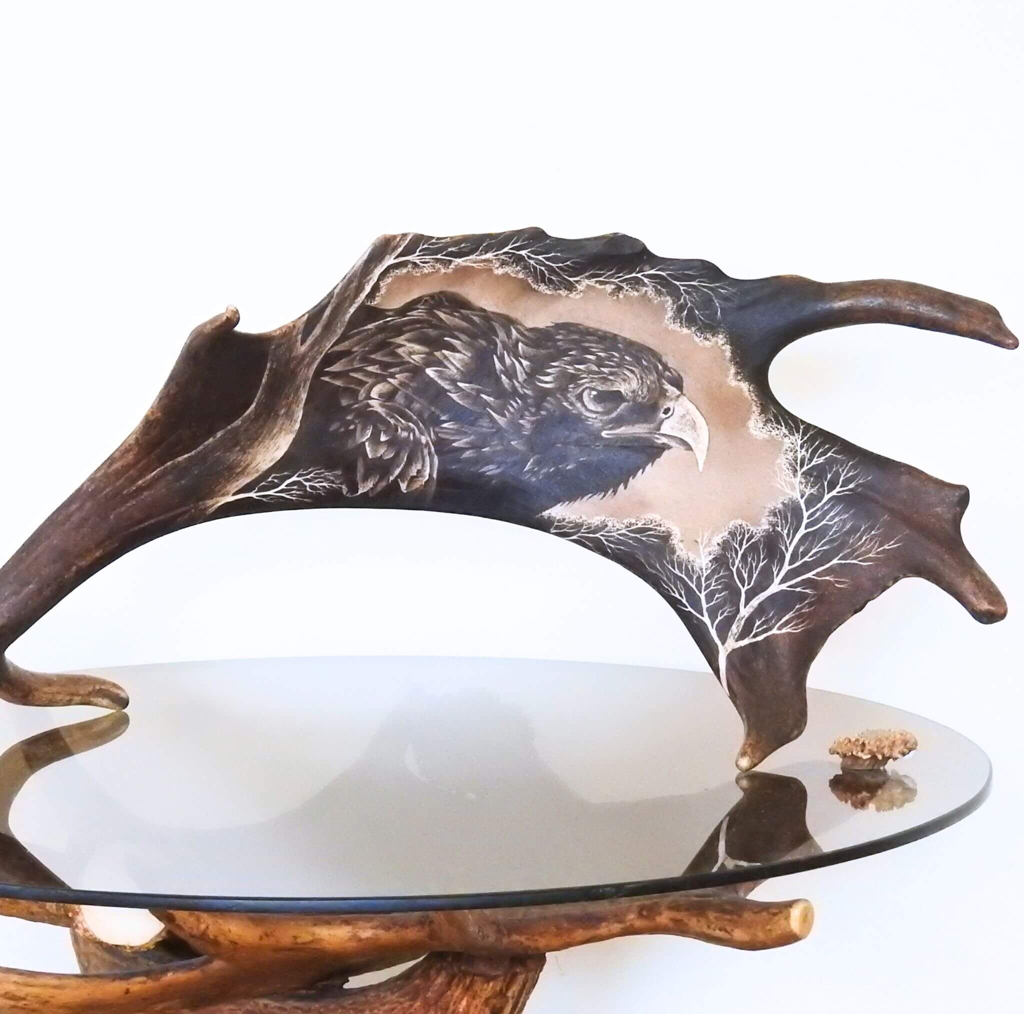 Antler carving shows head of eagle.