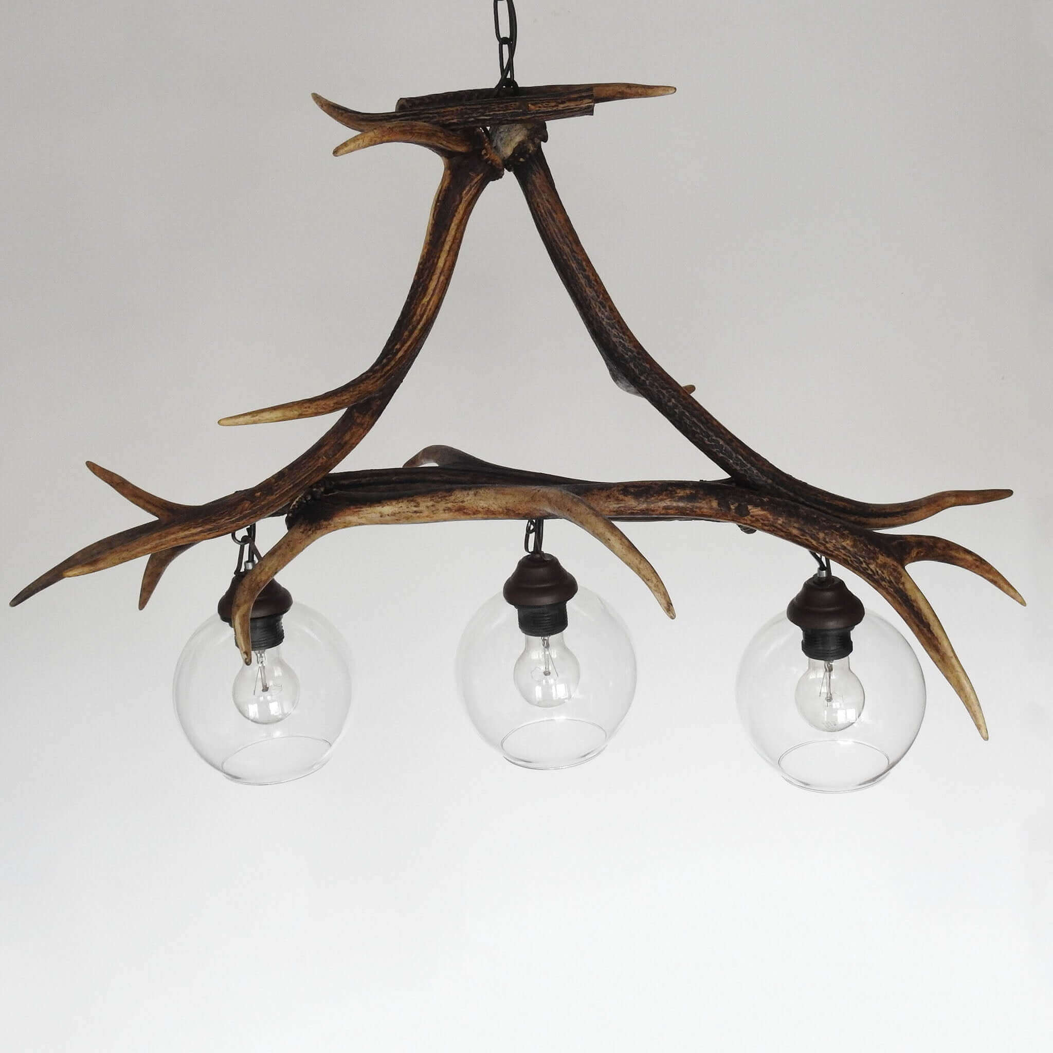 Long-shaped pendant lamp made of authentic red deer antlers - a unique and eye-catching lighting fixture.