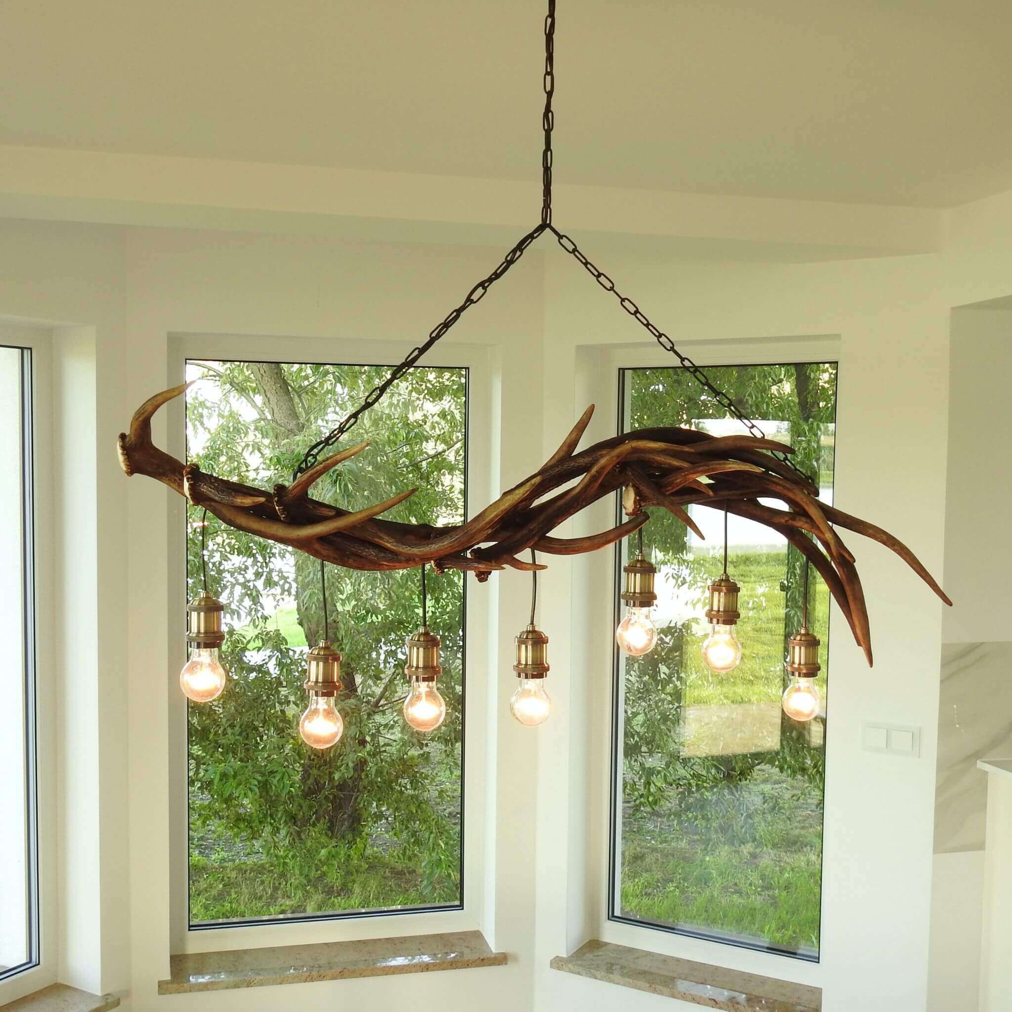 Antler chandelier lighting over the table.