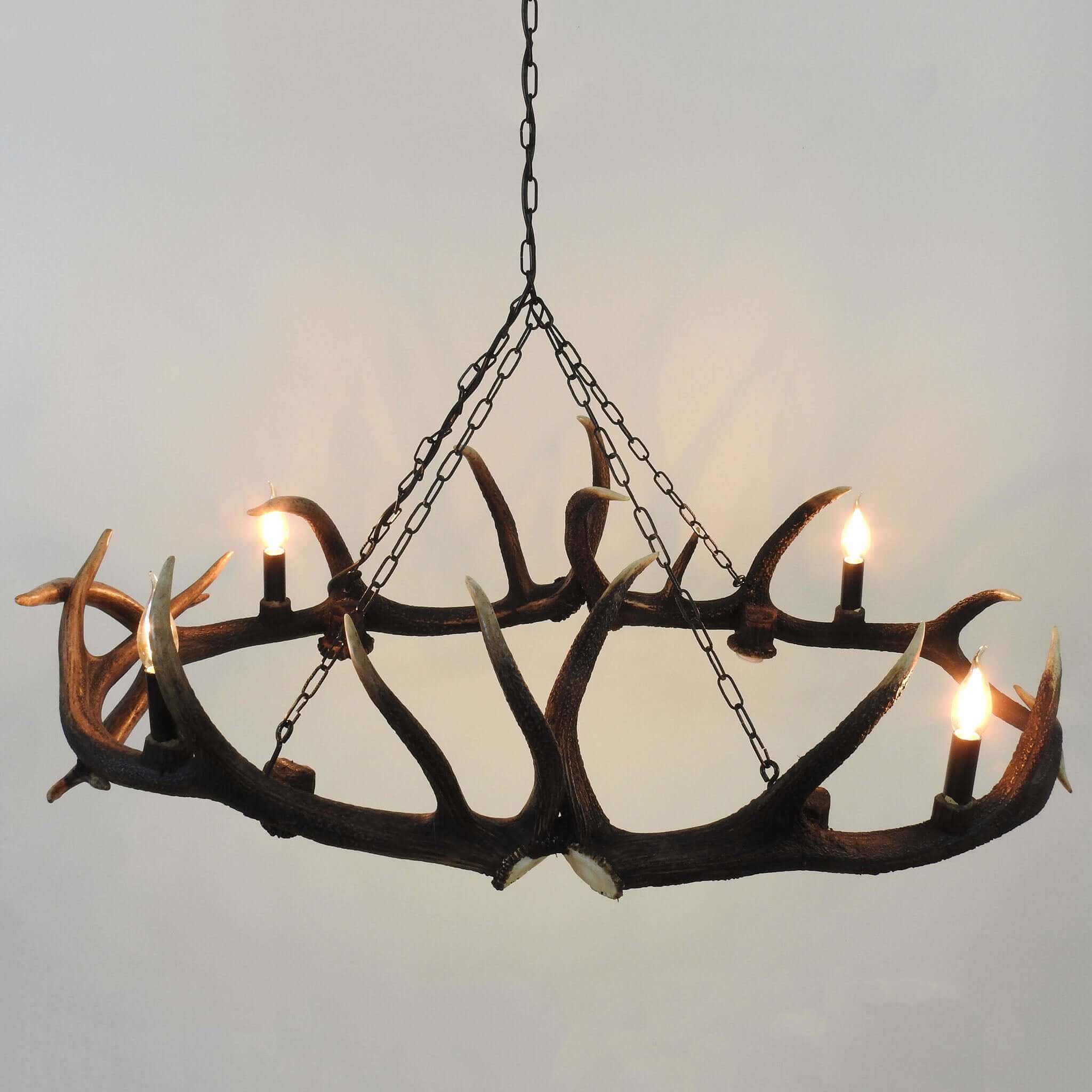 Real deer antler chandelier hanging on chain.