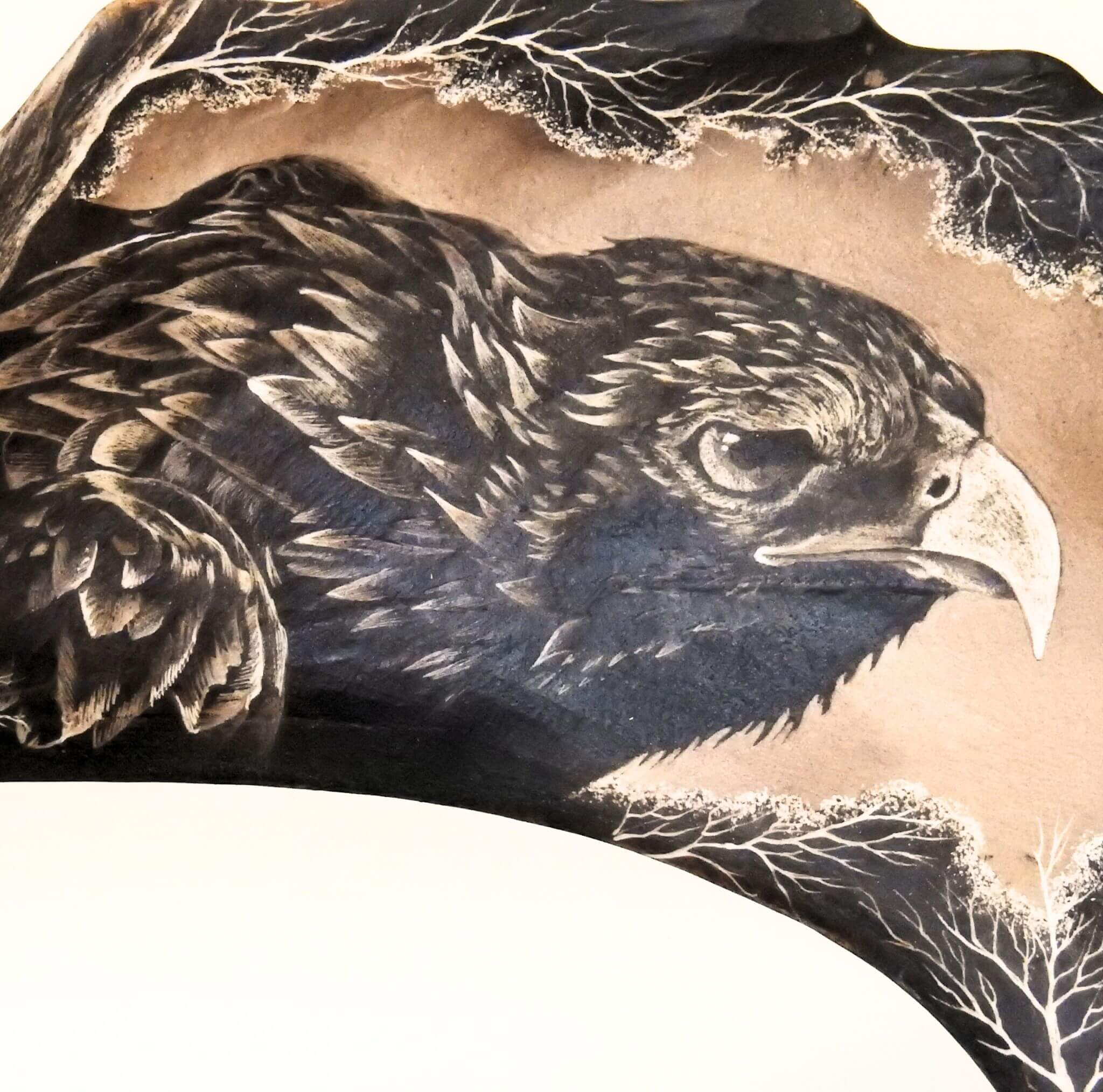 Close-up of a detailed engraving of an eagle on a textured surface.
