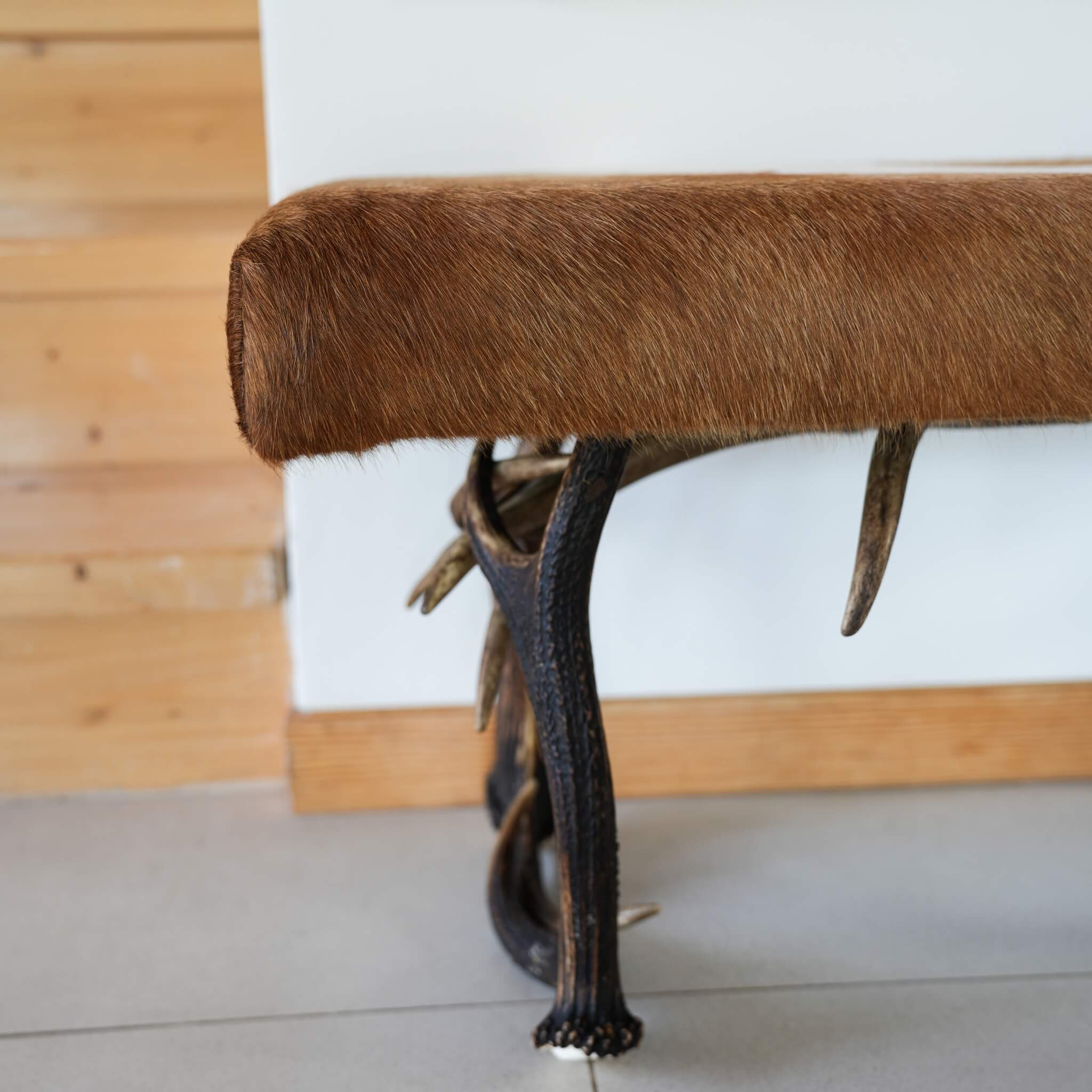 Details of cowhide in farmhouse bench made of antlers.