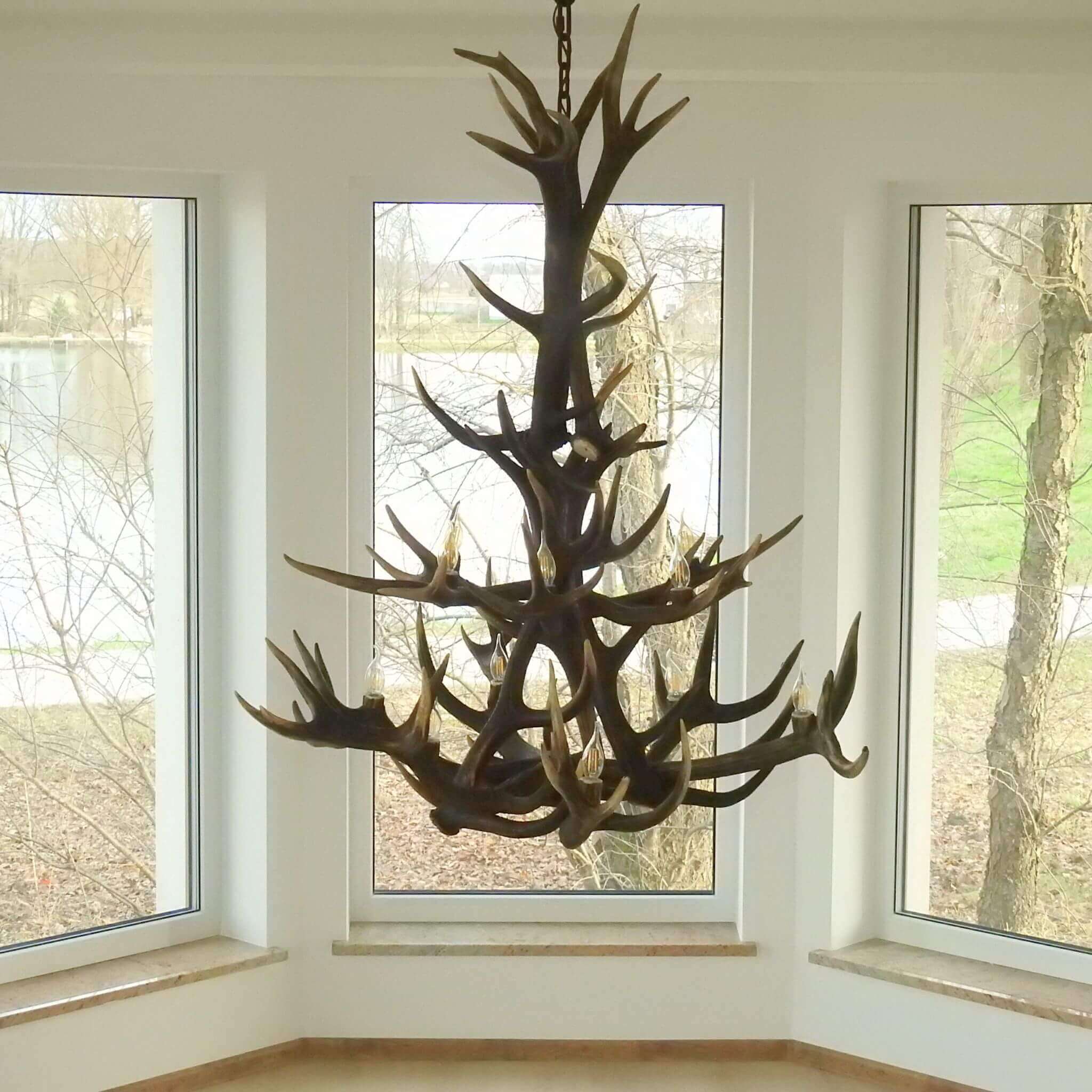 Large antler chandelier for farmhouse hanging in living room.