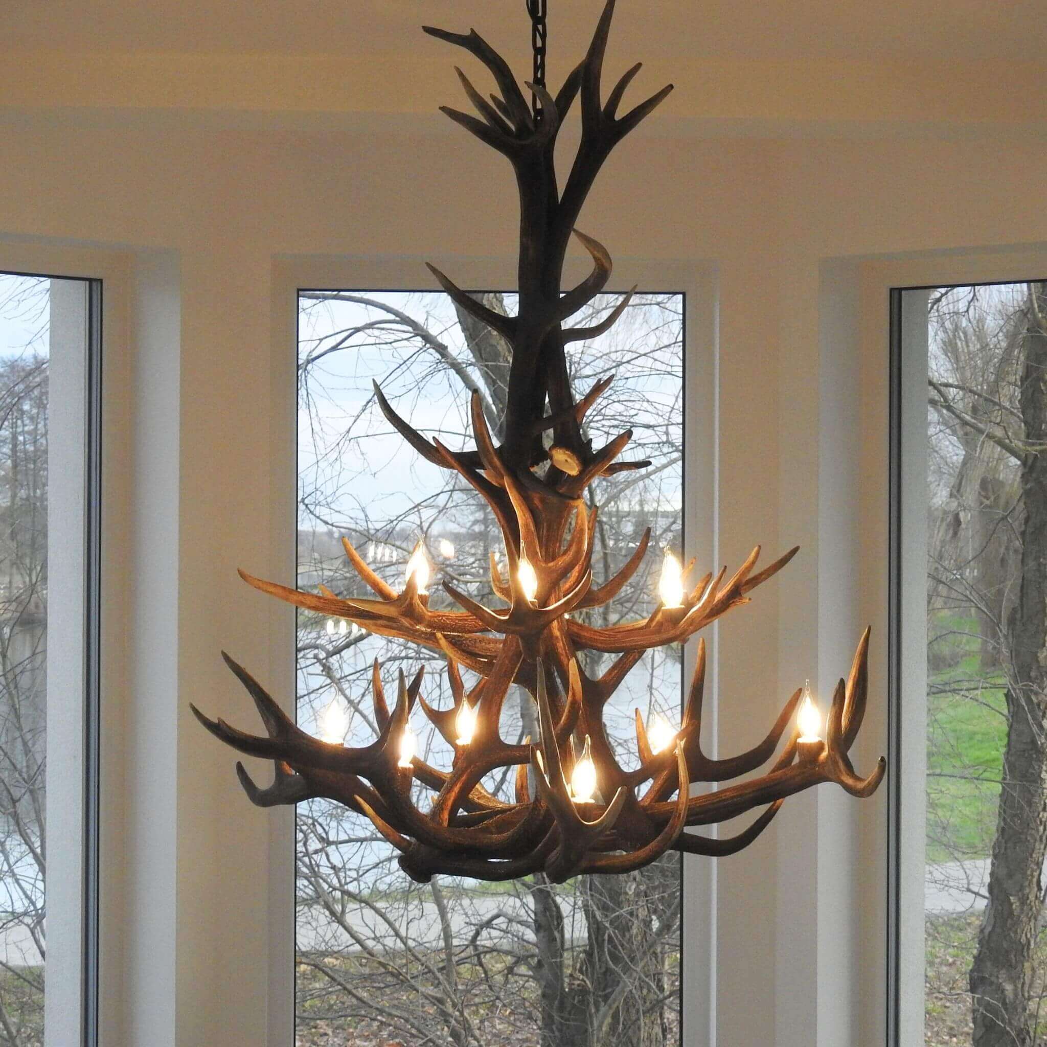 Farmhouse antler chandelier lighting, hanging on chain.