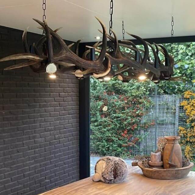 Real large, deer antler chandelier over the table.