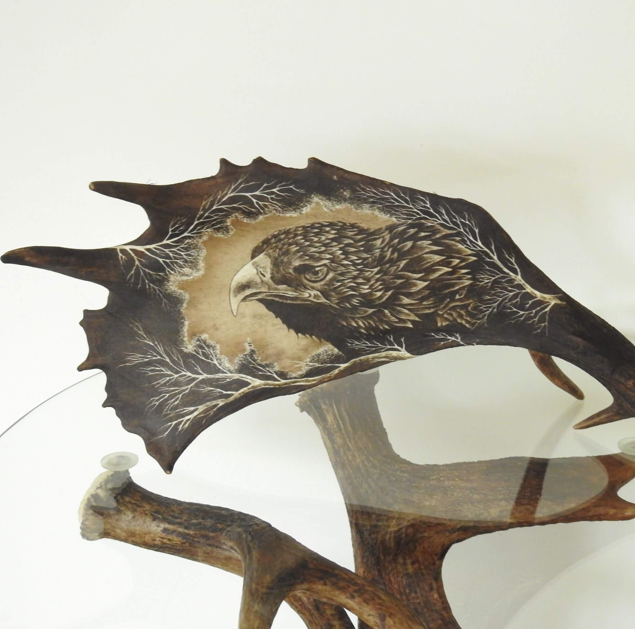 Decorative wall art with an eagle design on a white background.
