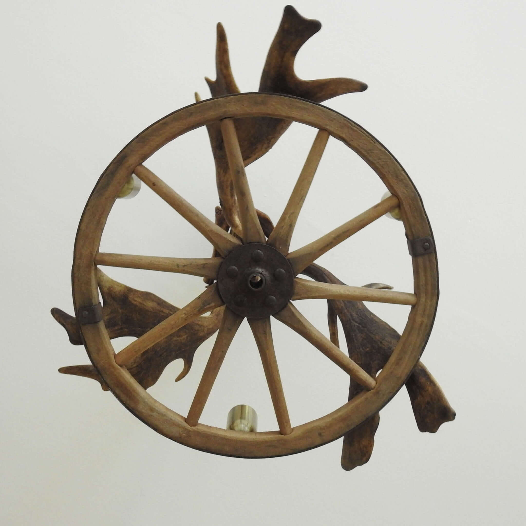Farmhouse antler chandelier with wagon wheel.