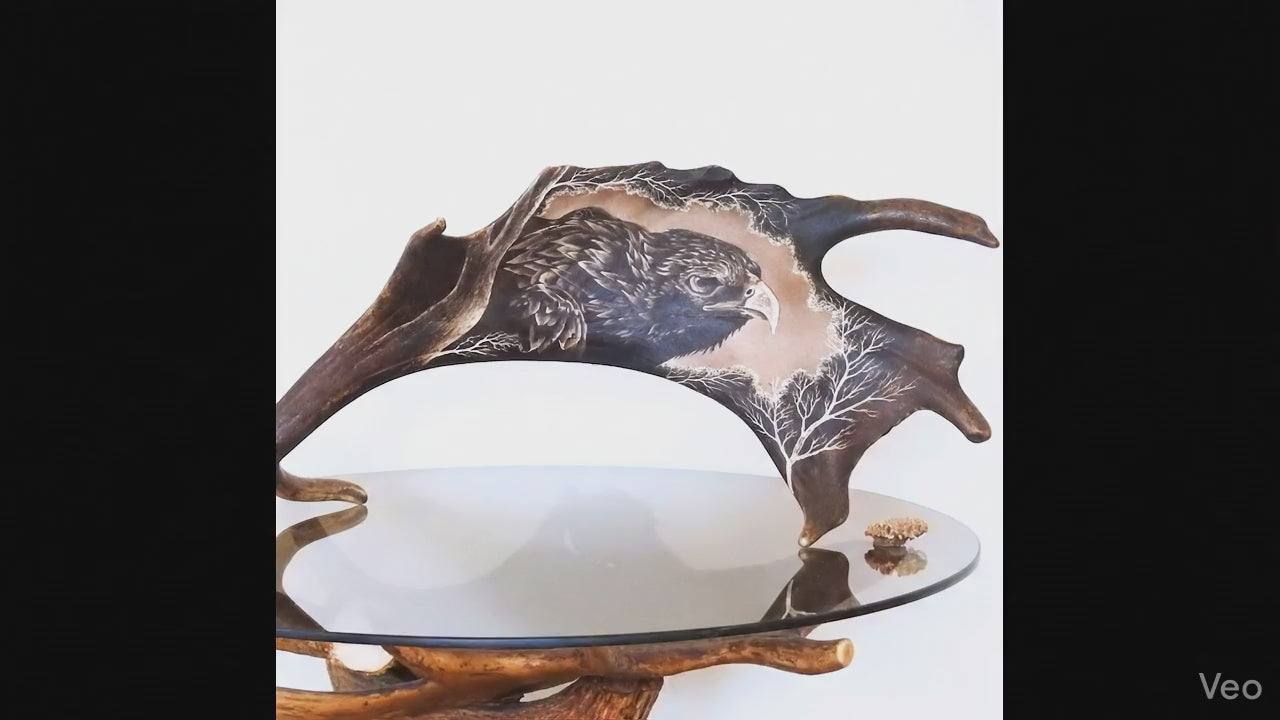 Real antler carving shows hed of eagle.